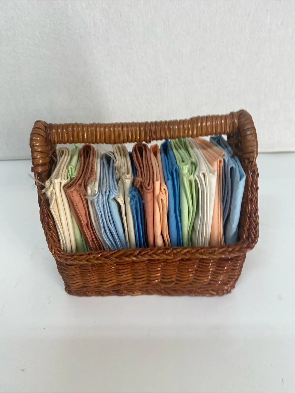 Wicker Basket Woven Rattan with Assorted Pastel Linens Cloths Storage Dainty